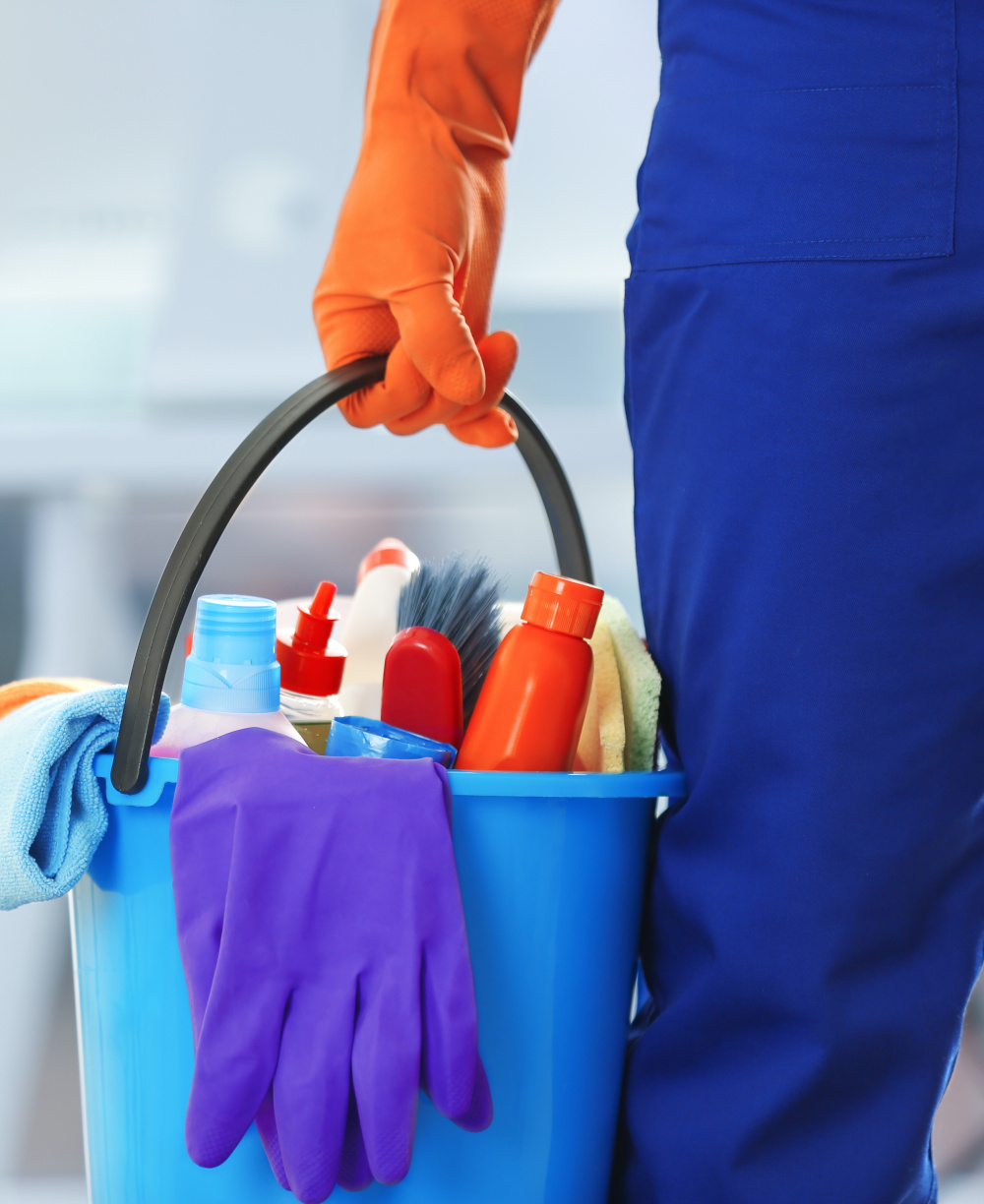 holding cleaning products and tools on bucket, close up